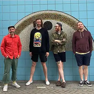 Слева направо: Питер Хелмис, Джо Рейнхарт, Ник Тацца и Колин Махони