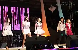 Wonder Girls dancing onstage in pink colored clothing